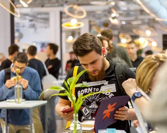 Visitors at a stand at a start-up event