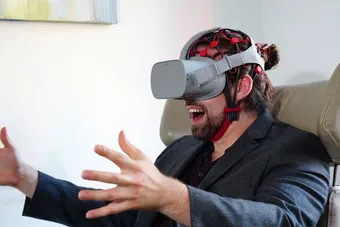 Man wearing an EEG cap and VR headset during neurofeedback training