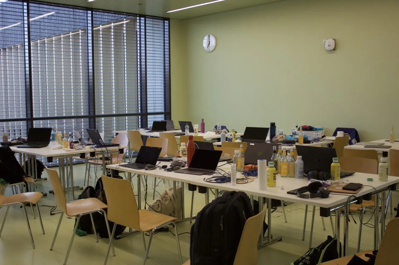 Team workstations with laptops in the hackathon room